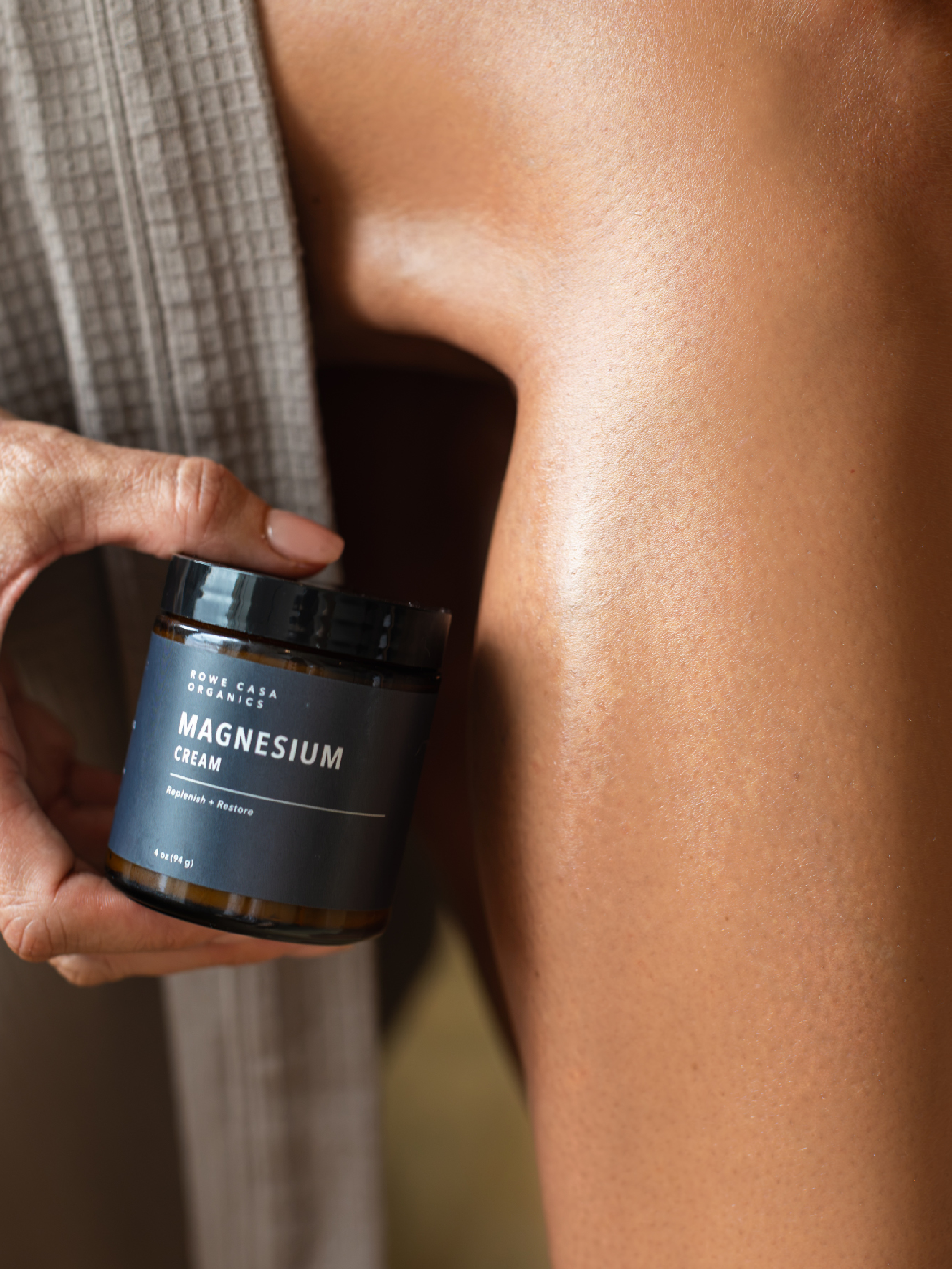 Topical magnesium cream applied to the shoulders for muscle tension, relaxation and post-workout recovery.