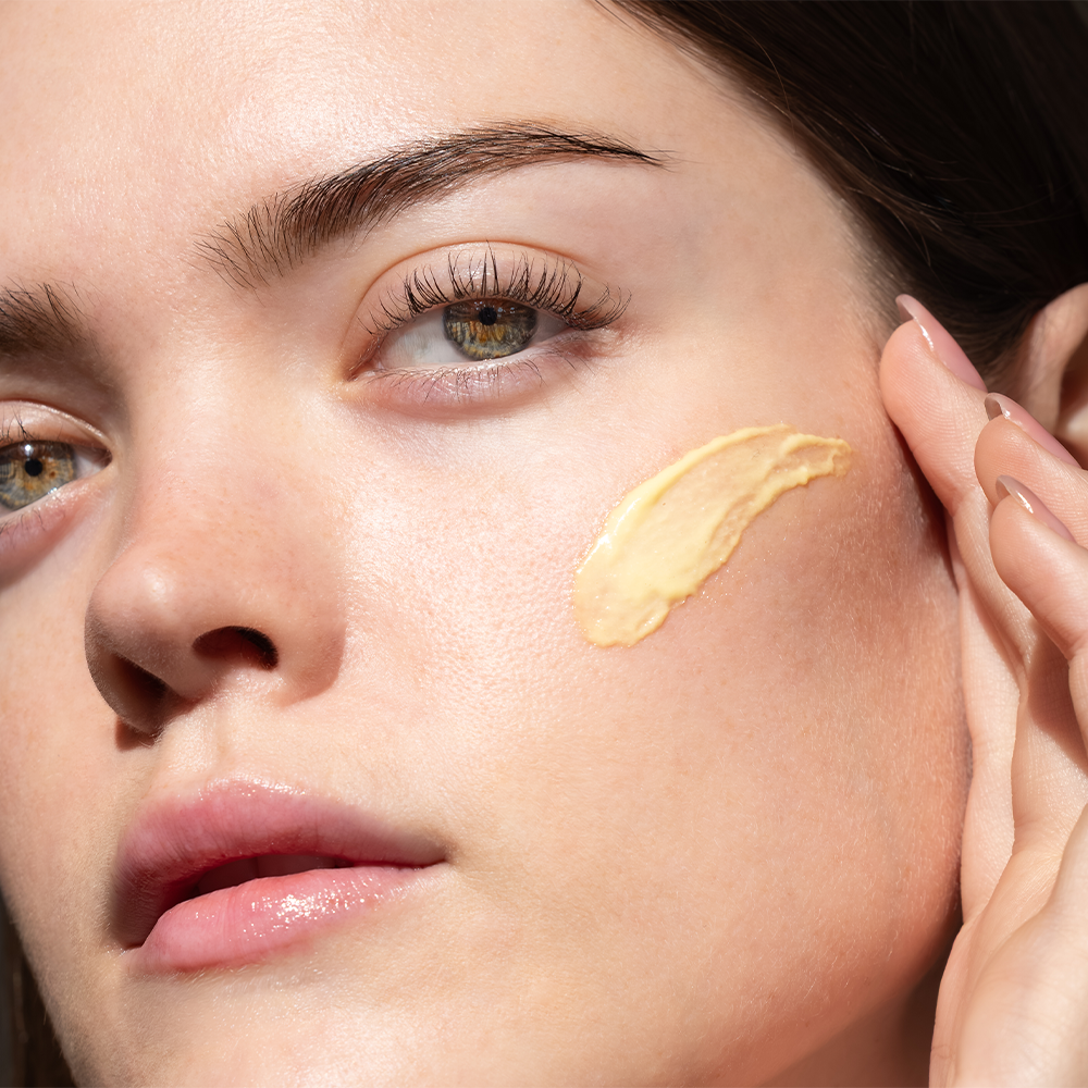 Applying a daily face moisturizer to hydrate dry skin as part of a morning and evening skincare routine.