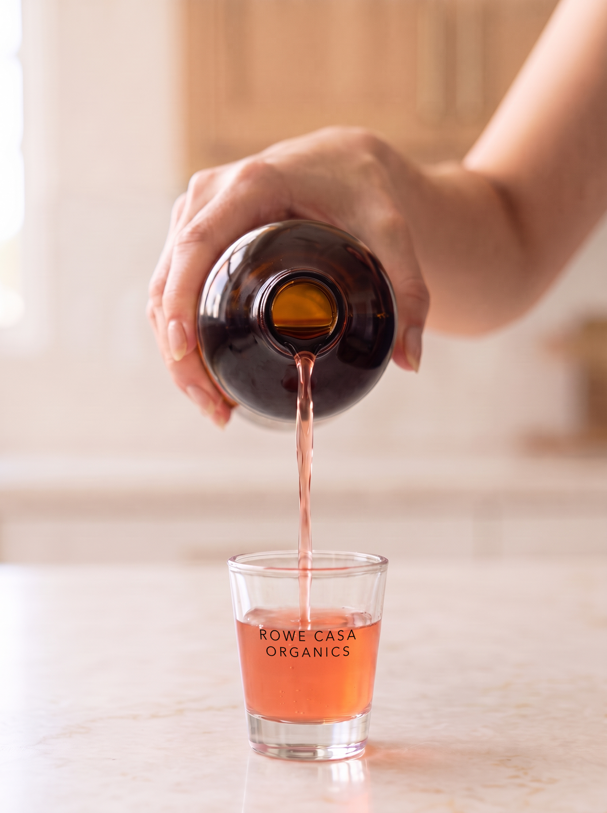 Pouring a daily shot of Vitality Energy Support for morning energy, focus and sustained energy throughout the day.