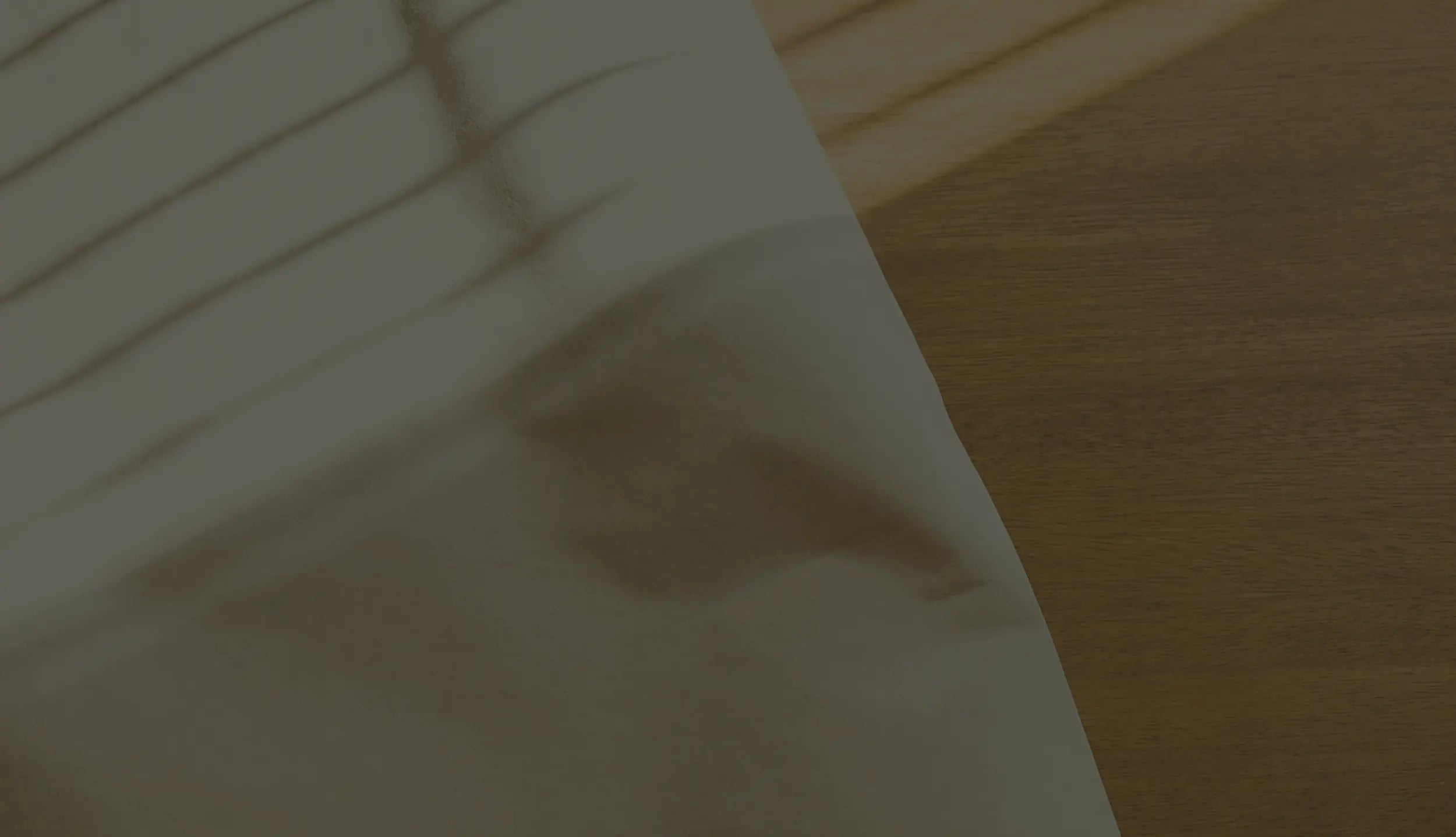 Sheet of white paper on a wooden surface